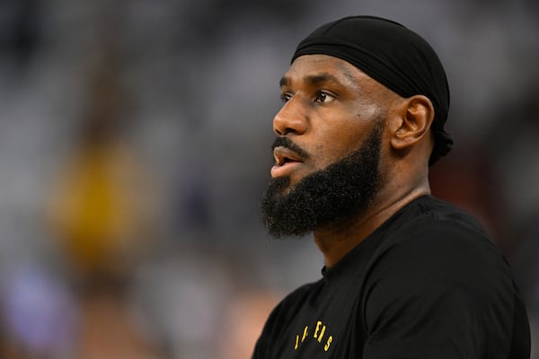 Los Angeles Lakers forward LeBron James stands on the court during warm ups before an NBA basketball game against the Golden State Warriors Wednesday, Dec. 25, 2024, in San Francisco. (AP Photo/Eakin Howard)