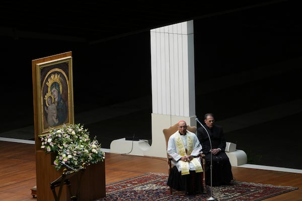 The Pope's vicar for the dioceses of Rome Cardinal Baldassarre Reina, left, during a rosary prayer held for the health of Pope Francis in St Peter's Square at The Vatican, Thursday, Feb. 27, 2025. (AP Photo/Kirsty Wigglesworth)