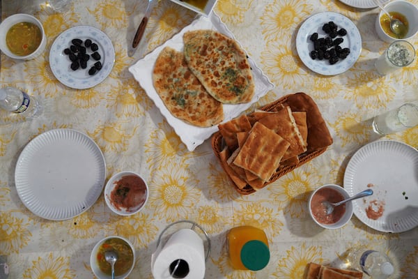 Bolani and other foods are prepared by Marjila Badakhsh and her roommates to break their daily fast during the Muslim holy month of Ramadan, in Alexandria, Va., Wednesday, March 5, 2025. (AP Photo/Jessie Wardarski)