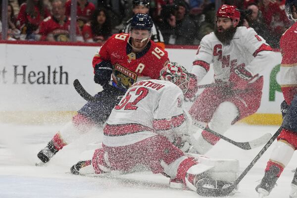 Carolina Hurricanes goaltender Pyotr Kochetkov (52) defends the goal against Florida Panthers left wing Matthew Tkachuk (19) during the second period in Game 3 of the NHL hockey Stanley Cup Eastern Conference finals Saturday, May 24, 2025, in Sunrise, Fla. (AP Photo/Lynne Sladky)
