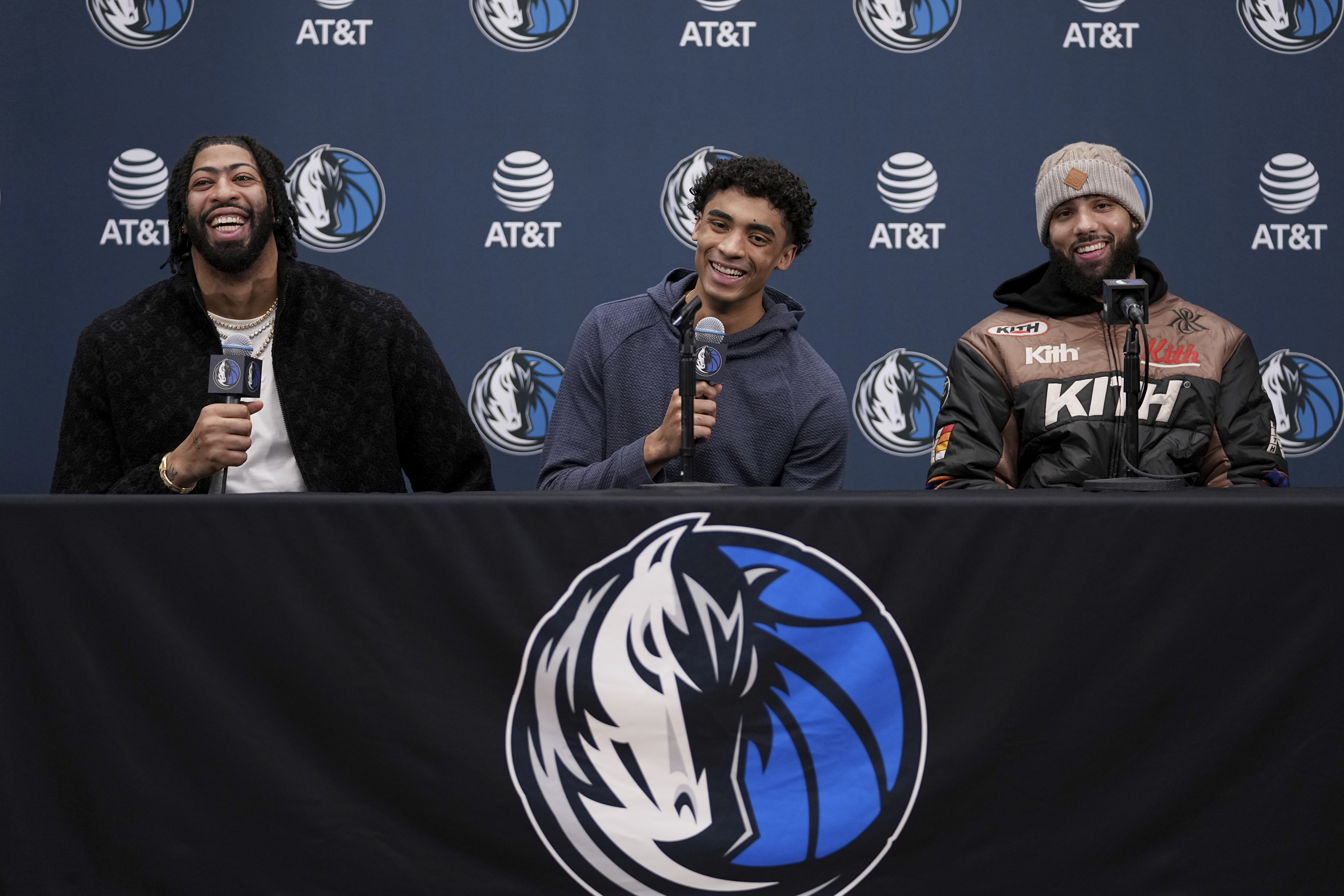 Newly acquired Dallas Mavericks players Anthony Davis, left, Max Christie, center, and Caleb Martin, right, laugh as they respond to a question during an NBA basketball news conference at the team's practice facility in Dallas, Friday, Feb. 7, 2025. (AP Photo/Tony Gutierrez)