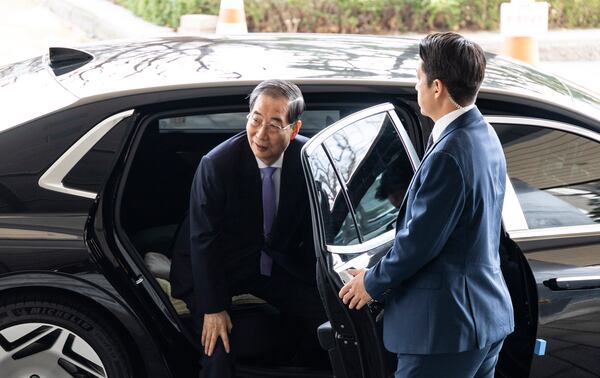 South Korean Prime Minister Han Duck-soo, left, arrives at the Government Complex in Seoul, South Korea Monday, March 24, 2025. (Heon-Kyun Jeon /Pool Photo via AP)