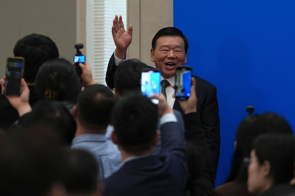 National People's Congress spokesperson Lou Qinjian waves after a press conference on the eve of the National People's Congress at the Great Hall of the People in Beijing, Tuesday, March 4, 2025. (AP Photo/Ng Han Guan)