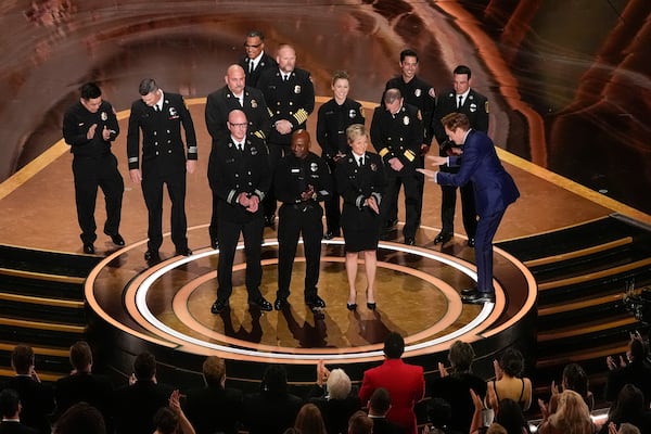 Members of the Los Angeles County Fire Department and Host Conan O'Brien, far right, on stage during the Oscars on Sunday, March 2, 2025, at the Dolby Theatre in Los Angeles. (AP Photo/Chris Pizzello)