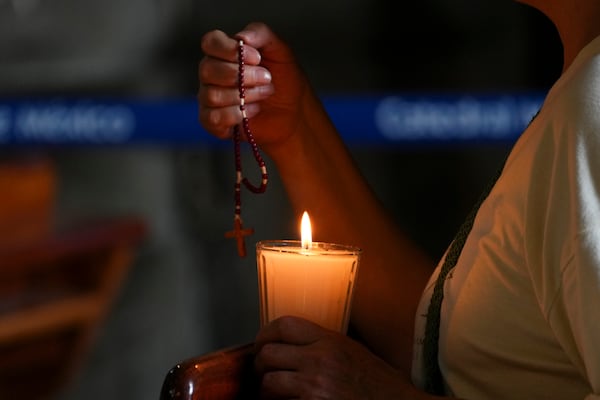 Parishioners pray for the health of Pope Francis at the Metropolitan Cathedral in Mexico City, Thursday, Feb. 27, 2025. (AP Photo/Marco Ugarte)