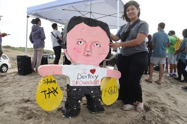 Natalia Salinas holds a piñata of Elon Musk during a protest at Boca Chica beach, Texas, on Saturday afternoon, May 3, 2025, hours before polls closed for the incorporation election that would turn Starbase into an official Texas city. (AP Photo/Valerie Gonzalez)
