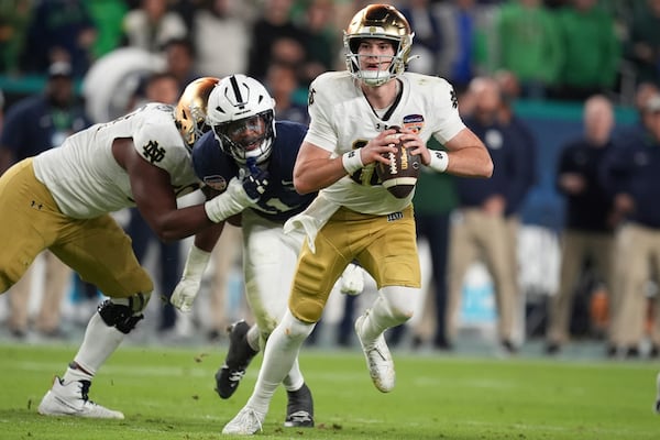 Notre Dame quarterback Steve Angeli (18) runs with the football during the first half of the Orange Bowl NCAA College Football Playoff semifinal game against Penn State, Thursday, Jan. 9, 2025, in Miami Gardens, Fla. (AP Photo/Rebecca Blackwell)