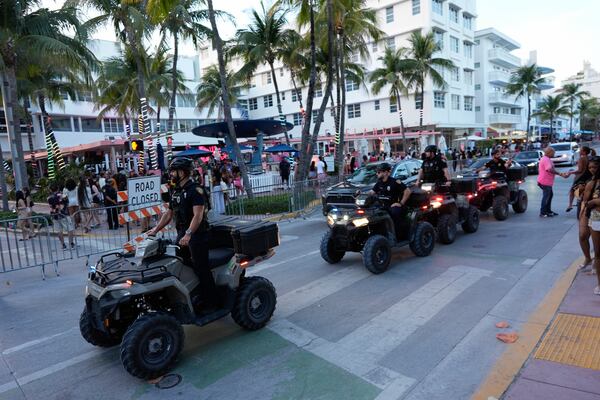 FILE - Police on all-terrain vehicles patrol along Ocean Drive during spring break, March 15, 2024, in Miami Beach, Fla. (AP Photo/Rebecca Blackwell, File)