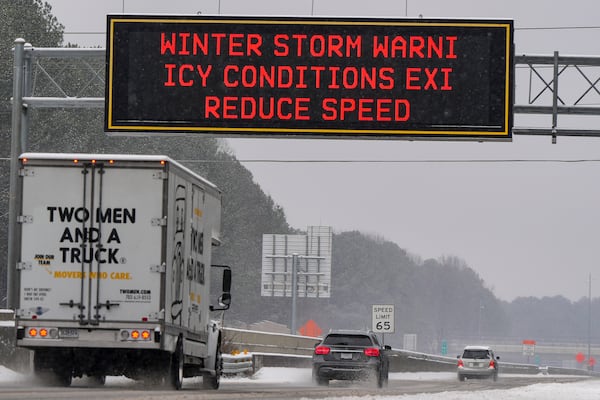 Vehicles move slowly on Interstate 575 during a winter storm, Friday, Jan. 10, 2025, in Kennesaw, Ga. (AP Photo/Mike Stewart)