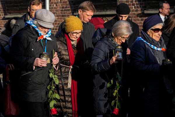 Survivors and relatives stand at the Auschwitz-Birkenau former Nazi German concentration and extermination camp, during a ceremony marking the 80th anniversary of the camp's liberation, in Oswiecim, Poland, Monday, Jan. 27. 2025.(AP Photo/Czarek Sokolowski)