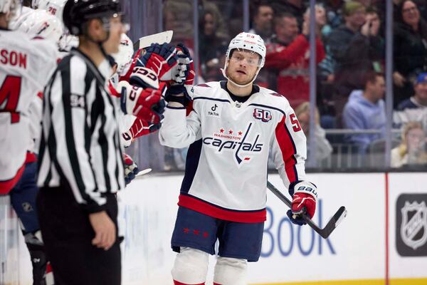 Washington Capitals center Ethen Frank (53) is congratulated after scoring against the Seattle Kraken during the second period of an NHL hockey game, Thursday, Jan. 23, 2025, in Seattle. (AP Photo/John Froschauer)