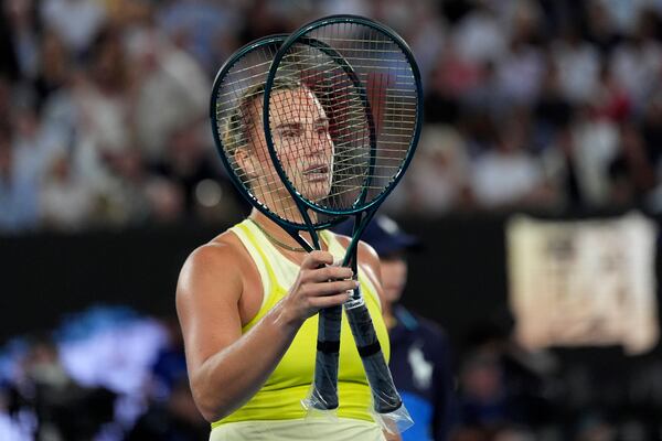 Aryna Sabalenka of Belarus gestures to have some rackets restrung during the women's singles final against Madison Keys of the U.S. at the Australian Open tennis championship in Melbourne, Australia, Saturday, Jan. 25, 2025. (AP Photo/Ng Han Guan)