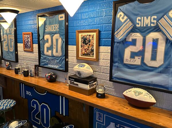 Signed jerseys of Detroit Lions NFL football greats Lem Barney, Barry Sanders and Billy Sims are displayed in fan Rob Gonzales' basement Thursday, Jan. 16, 2025, in Frenchtown Township, Mich. (AP Photo/Mike Householder)