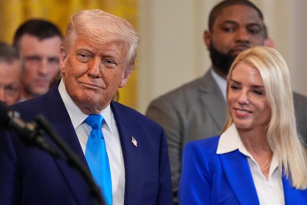 President Donald Trump and Attorney General Pam Bondi listen as head coach Todd Golden speaks as Trump hosts the 2025 NCAA Champion, University of Florida men's basketball team in the East Room of the White House, Wednesday, May 21, 2025, in Washington. (AP Photo/Julia Demaree Nikhinson)