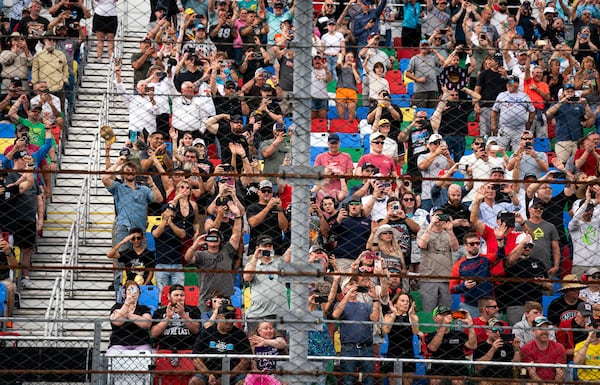 NASCAR fans watch as President Donald Trump attends the NASCAR Daytona 500 auto race at Daytona International Speedway, Sunday, Feb. 16, 2025, in Daytona Beach, Fla. (Pool via AP)