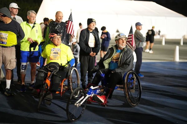 Rick Bingham, right, prepares for the start of the Los Angeles Marathon Sunday, March 16, 2025, in Los Angeles. (AP Photo/Eric Thayer)