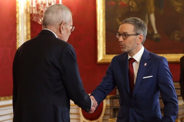 Austrian President Alexander Van der Bellen, left, welcomes head of the Freedom Party (FPOe) Herbert Kickl in his office, in Vienna, Austria, Monday, Jan. 6, 2025. (AP Photo/Heinz-Peter Bader)