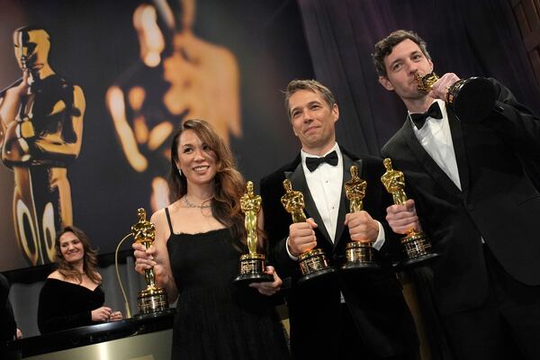 Samantha Quan, from left, winner of the award for best picture for "Anora, Sean Baker, winner of the awards for best original screenplay, best film editing, best director, and best picture for "Anora," and Alex Coco, winner of the award for best picture for "Anora," attend the Governors Ball after the Oscars on Sunday, March 2, 2025, in Los Angeles. (AP Photo/John Locher)