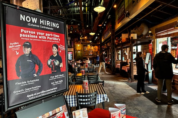 A hiring sign is displayed at a restaurant in Skokie, Ill., Wednesday, Jan. 8, 2025. (AP Photo/Nam Y. Huh)