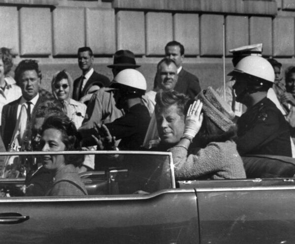 FILE - This Nov. 22, 1963 file photo shows President John F. Kennedy riding in motorcade with first lady Jacqueline Kenndy in Dallas, Texas. (AP Photo, file)