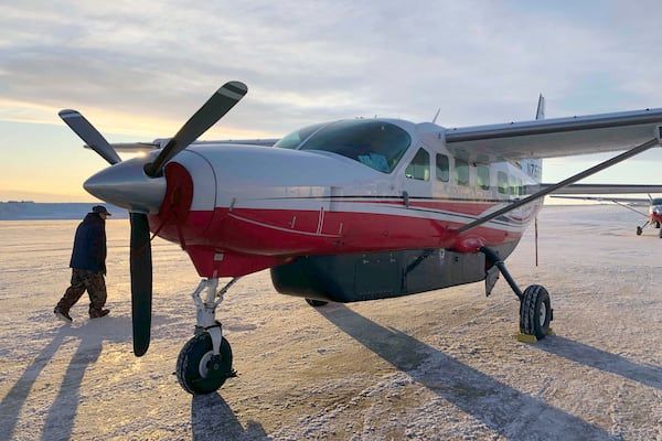 FILE - People prepare to get on an airplane at the airport in Bethel, Alaska, for a flight to Toksook Bay. (AP Photo/Mark Thiessen, File)