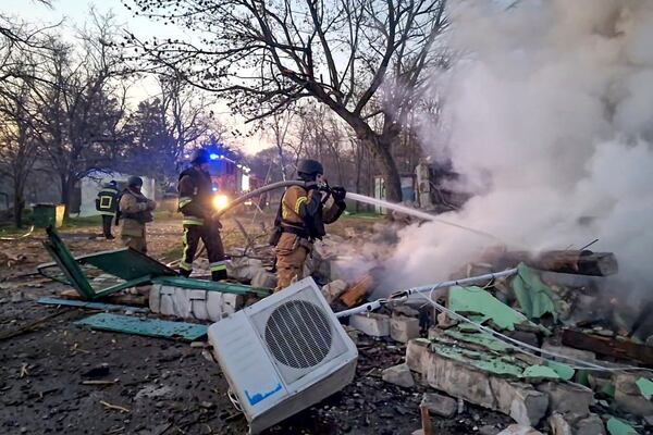 In this photo provided by the Ukrainian Emergency Service, firefighters put out the fire at a storehouse following a Russian attack in Odesa, Ukraine, Friday, March 21, 2025. (Ukrainian Emergency Service via AP)