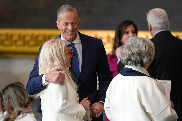 Senate Majority Leader John Thune, R-S.D., hugs Miriam Adelson before the 60th Presidential Inauguration in the Rotunda of the U.S. Capitol in Washington, Monday, Jan. 20, 2025. (AP Photo/Julia Demaree Nikhinson, Pool)