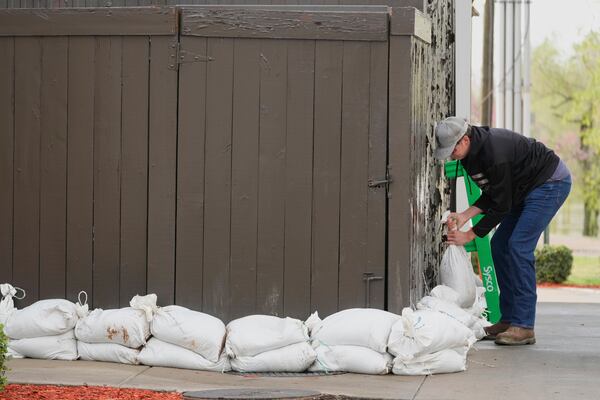 FILE - John Milt places sandbags in preparation for flooding near the banks of the Cumberland River in Clarksville Tenn., Friday, April 4, 2025. (AP Photo/George Walker IV, File)
