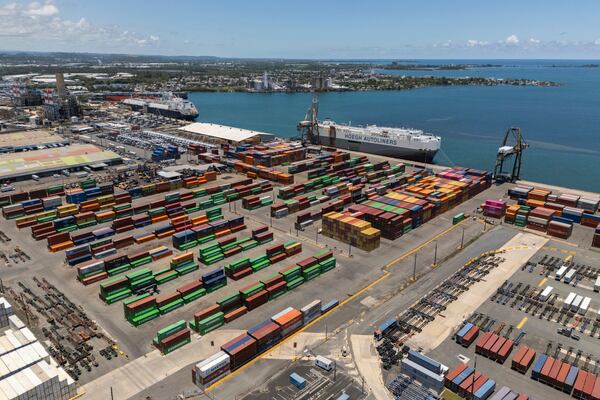 Tractor trailers and containers fill a shipping yard at the San Juan port in Puerto Rico, Thursday, May 8, 2025. (AP Photo/Alejandro Granadillo)