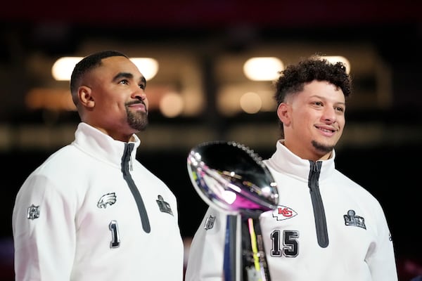 Philadelphia Eagles quarterback Jalen Hurts (1) and Kansas City Chiefs quarterback Patrick Mahomes (15) pose with the trophy during Super Bowl 59 Opening Night, Monday, Feb. 3, 2025, in New Orleans, ahead of the NFL football game between the Philadelphia Eagles and the Kansas City Chiefs Sunday. (AP Photo/Brynn Anderson)