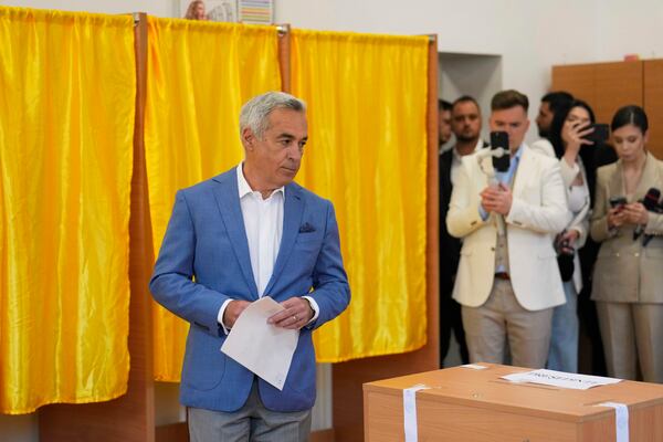 Calin Georgescu, winner of the first round of last year's annulled election, exits a voting booth before casting his vote in the first round of the presidential election redo in Bucharest, Romania, Sunday, May 4, 2025. (AP Photo/Vadim Ghirda)