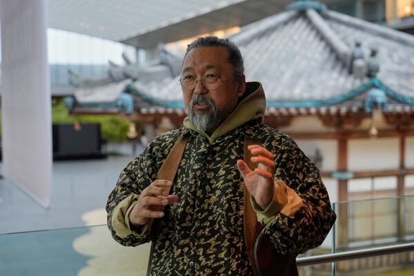 Artist Takashi Murakami is pictured during an interview in front of a true-to-scale recreation of the Yumedono from the Horyuji Temple complex in Nara, at the Cleveland Museum of Art in Cleveland, Thursday, May 15, 2025. (AP Photo/Sue Ogrocki)