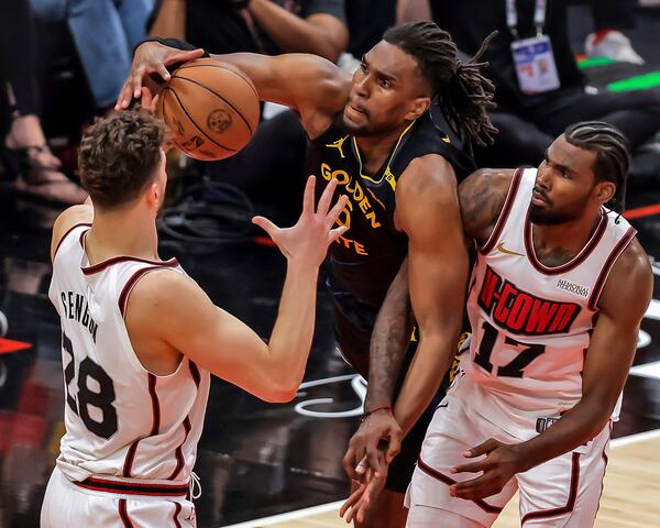 Golden State Warriors' Kevon Looney (5) grabs a rebound in the first half against the Houston Rockets in Game 7 of an NBA basketball first-round playoff series in Houston, Sunday, May 4, 2025. (Carlos Avila Gonzalez/San Francisco Chronicle via AP)