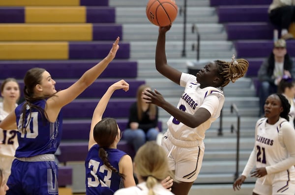 Grand Island High School's Nyaruot Wal puts up a shot over two Kearney defenders during a girls high school basketball game, Jan 4, 2024, n Grand Island, Neb. (Josh Salmon/The Independent via AP)