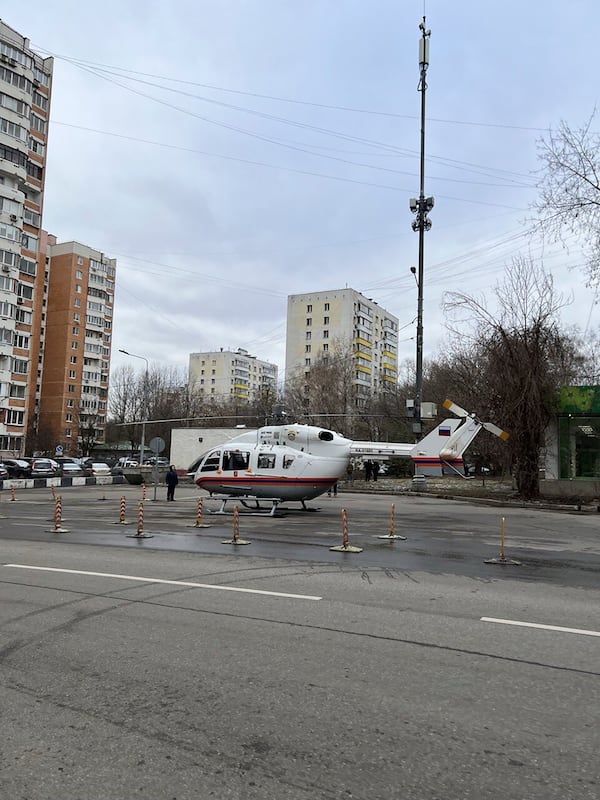 A helicopter of Russian Emergency Situations Ministry stands near an upscale residential block in Moscow, Russia, Monday, Feb. 3, 2025, where the blast has killed one person and wounded four others, Russian news agencies say. (Moscow News Agency via AP)