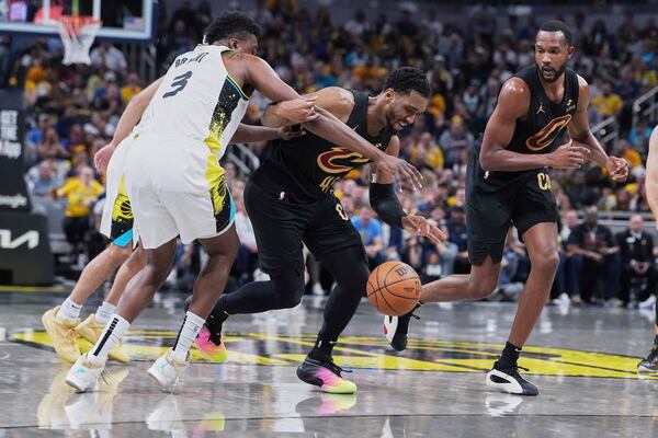 Cleveland Cavaliers guard Donovan Mitchell (45) chases down the ball against Indiana Pacers center Thomas Bryant (3) in the first half of Game 4 in the Eastern Conference semifinals of the NBA basketball playoffs in Indianapolis, Sunday, May 11, 2025. (AP Photo/Michael Conroy)