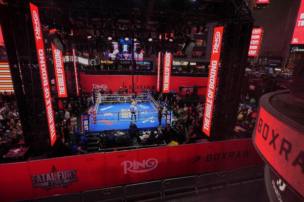 Fans watch Teofimo Lopez and Arnold Barboza Jr. fight during a super lightweight boxing match in Times Square Friday, May 2, 2025, in New York. (AP Photo/Frank Franklin II)