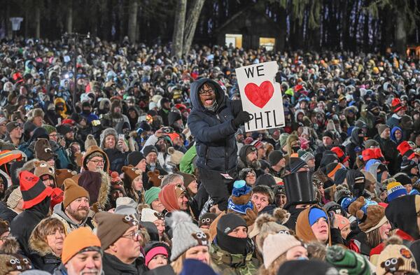 The crowd watches the festivities while waiting for Punxsutawney Phil, the weather prognosticating groundhog, to come out and make his prediction during the 139th celebration of Groundhog Day on Gobbler's Knob in Punxsutawney, Pa., Sunday, Feb. 2, 2025. (AP Photo/Barry Reeger)