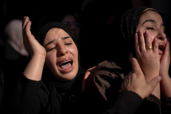 Relatives mourn during the funeral of Palestinian Muhammad Abu Amer, 18, who was killed at night in an Israeli army raid, in the West Bank refugee camp of Balata, Nablus, Saturday, Jan. 4, 2025. (AP Photo/Majdi Mohammed)