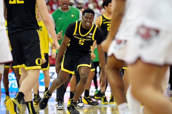 Oregon guard TJ Bamba (5) reacts to the end of regulation as Oregon guard Jackson Shelstad (3) tied the game to take it into overtime against Wisconsin in the second half of an NCAA college basketball game Saturday, Feb. 22, 2025, in Madison, Wis. (AP Photo/Kayla Wolf)