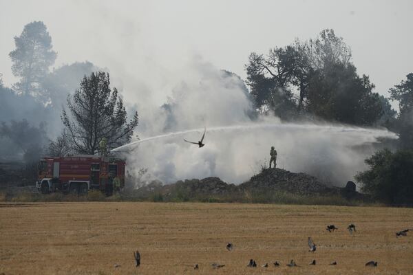 An Israeli crew battles a wild fire near Latrun, Israel, outside of Jerusalem Thursday, May 1, 2025. (AP Photo/Ohad Zwigenberg)