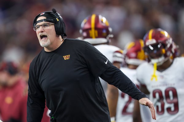 Washington Commanders head coach Dan Quinn reacts to a fourth-down stop against the Dallas Cowboys during the first half of an NFL football game, Sunday, Jan. 5, 2025, in Arlington, Texas. (AP Photo/Gareth Patterson)