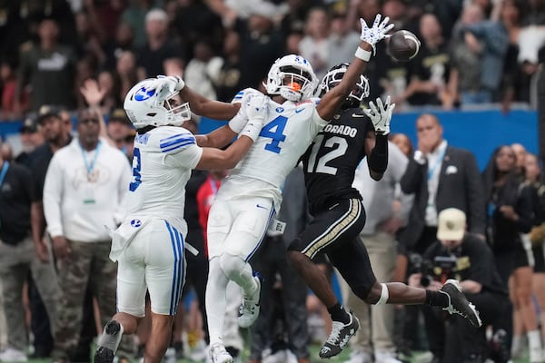 BYU cornerback Mory Bamba (4) knocks away a pass intended for Colorado wide receiver Travis Hunter (12) during the second half of the Alamo Bowl NCAA college football game, Saturday, Dec. 28, 2024, in San Antonio. (AP Photo/Eric Gay)