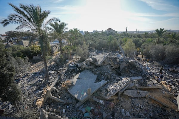 Palestinians look at home destroyed by an Israeli strike late Saturday in Deir al-Balah Sunday, Dec. 22, 2024. At least eight people were killed according to the hospital which received the bodies.(AP Photo/Abdel Kareem Hana)