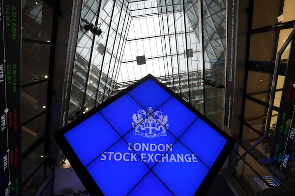 A logo is displayed inside the London Stock Exchange, in the City of London, Monday, March 17, 2025. (AP Photo/Kin Cheung)