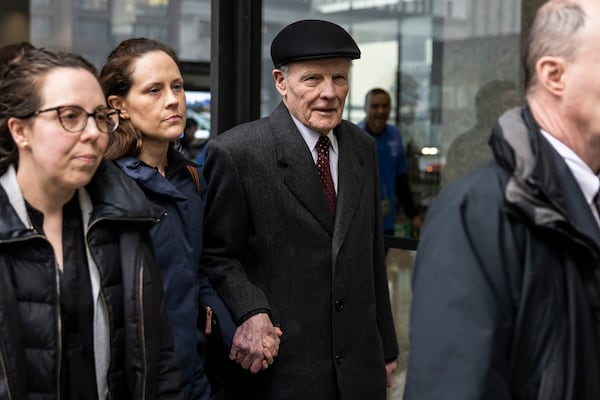 Flanked by supporters and holding hands with his daughter Nicole, Illinois' former House Speaker Michael Madigan walks out of the Dirksen Federal Courthouse in Chicago, Wednesday, Feb. 12, 2025. (Ashlee Rezin/Chicago Sun-Times via AP)