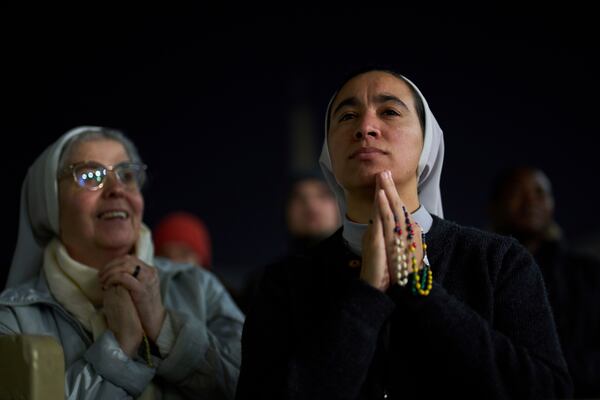 Catholic nuns listen to a recorded message from Pope Francis during a prayer of the Rosary for Pope Francis in St. Peter's Square at The Vatican, Thursday, March 6, 2025. (AP Photo/Francisco Seco)