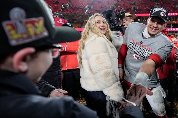 Kansas City Chiefs quarterback Patrick Mahomes and his wife Brittany Mahomes speak to a fan after the AFC Championship NFL football game against the Buffalo Bills, Sunday, Jan. 26, 2025, in Kansas City, Mo. (AP Photo/Ashley Landis)