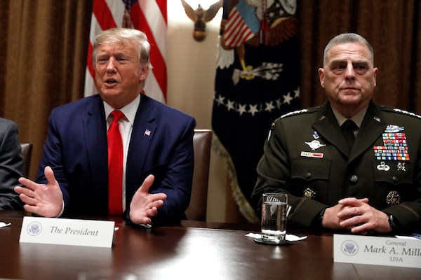 FILE - President Donald Trump speaks as the Chairman of the Joint Chiefs of Staff Gen. Mark Milley, right, listens during a briefing with senior military leaders in the Cabinet Room at the White House in Washington, Monday, Oct. 7, 2019. (AP Photo/Carolyn Kaster, File)