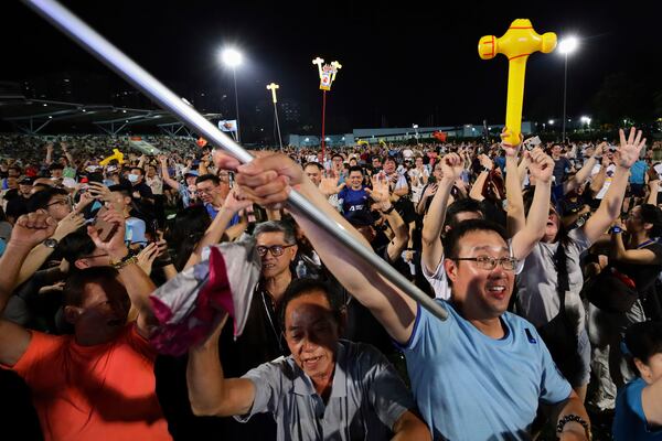 Workers' Party (WP) supporters react at an assembly centre during the general election, in Singapore, Saturday, May 3, 2025. (AP Photo/Suhaimi Abdullah)